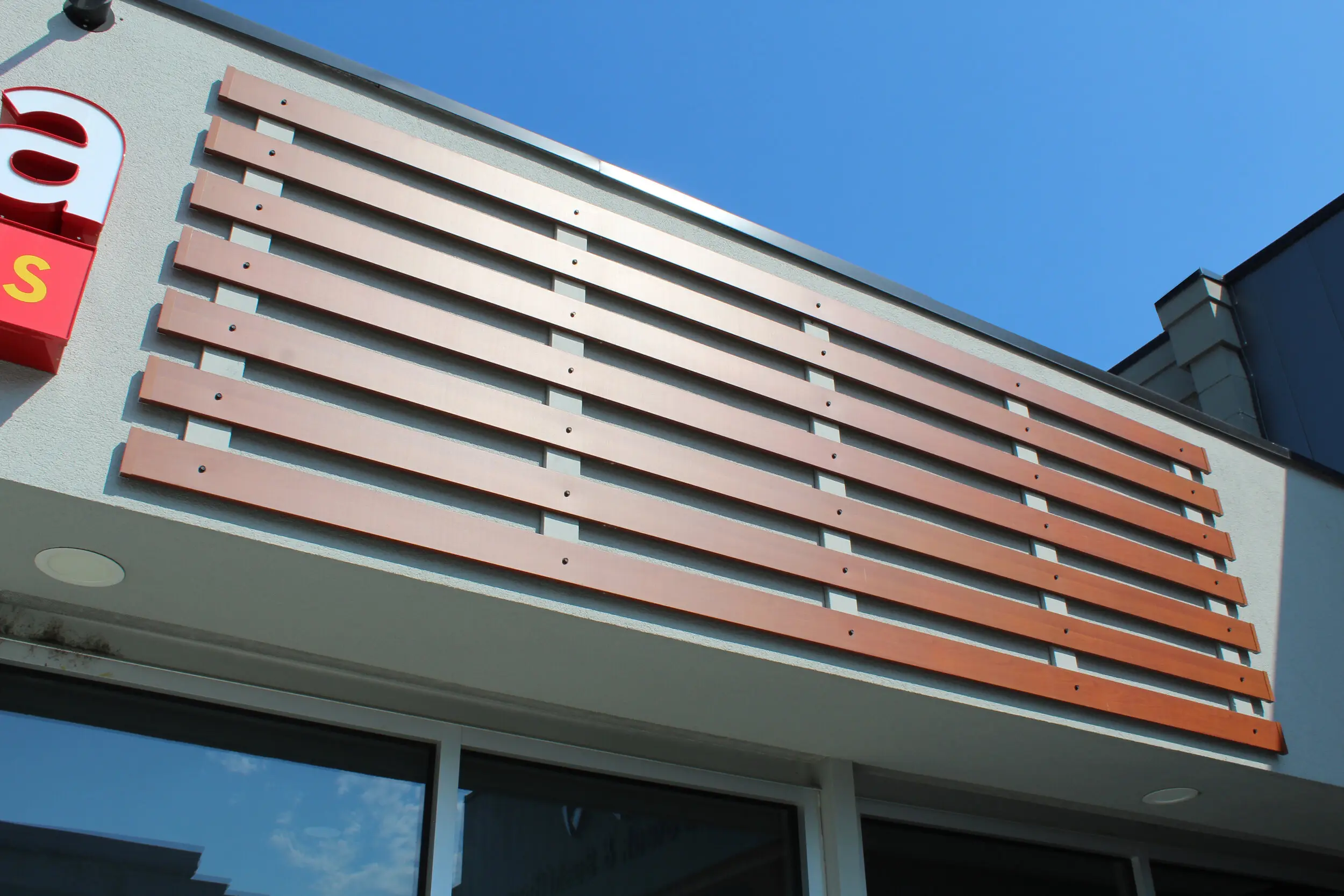 Commercial building façade with horizontal AFX woodgrain aluminum slats