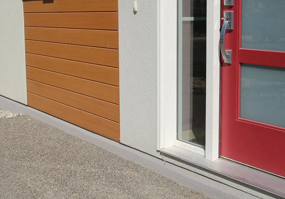 AFX woodgrain aluminum cladding beside a red entry door