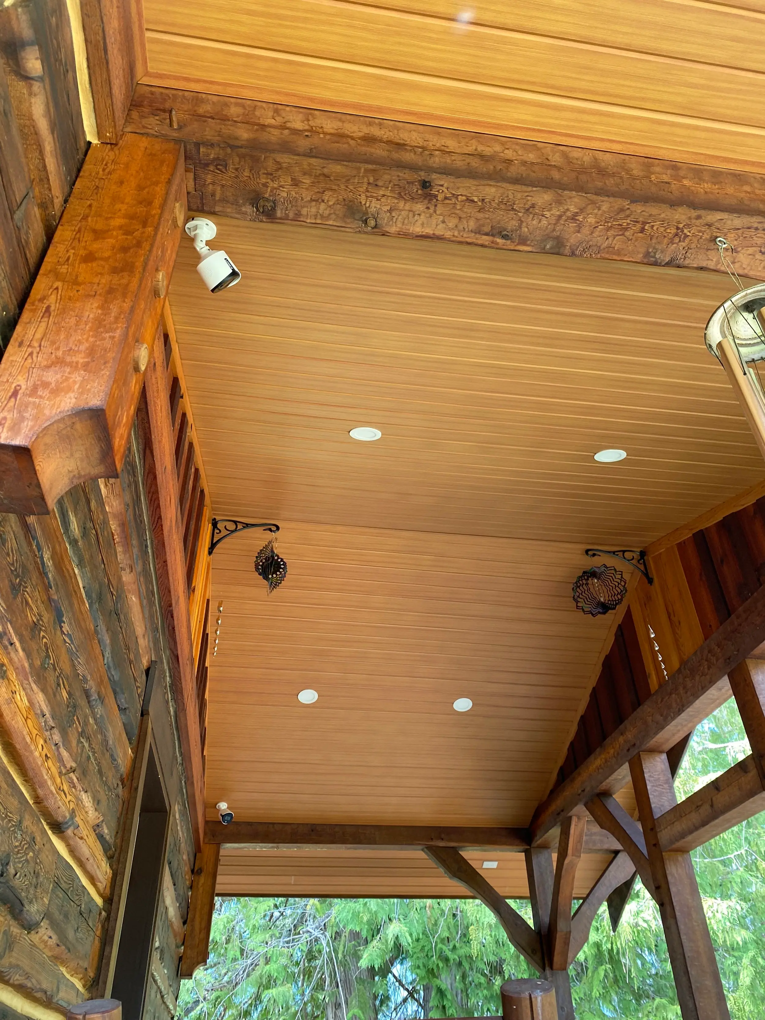 Porch ceiling finished in AFX woodgrain aluminum soffit with pot lights