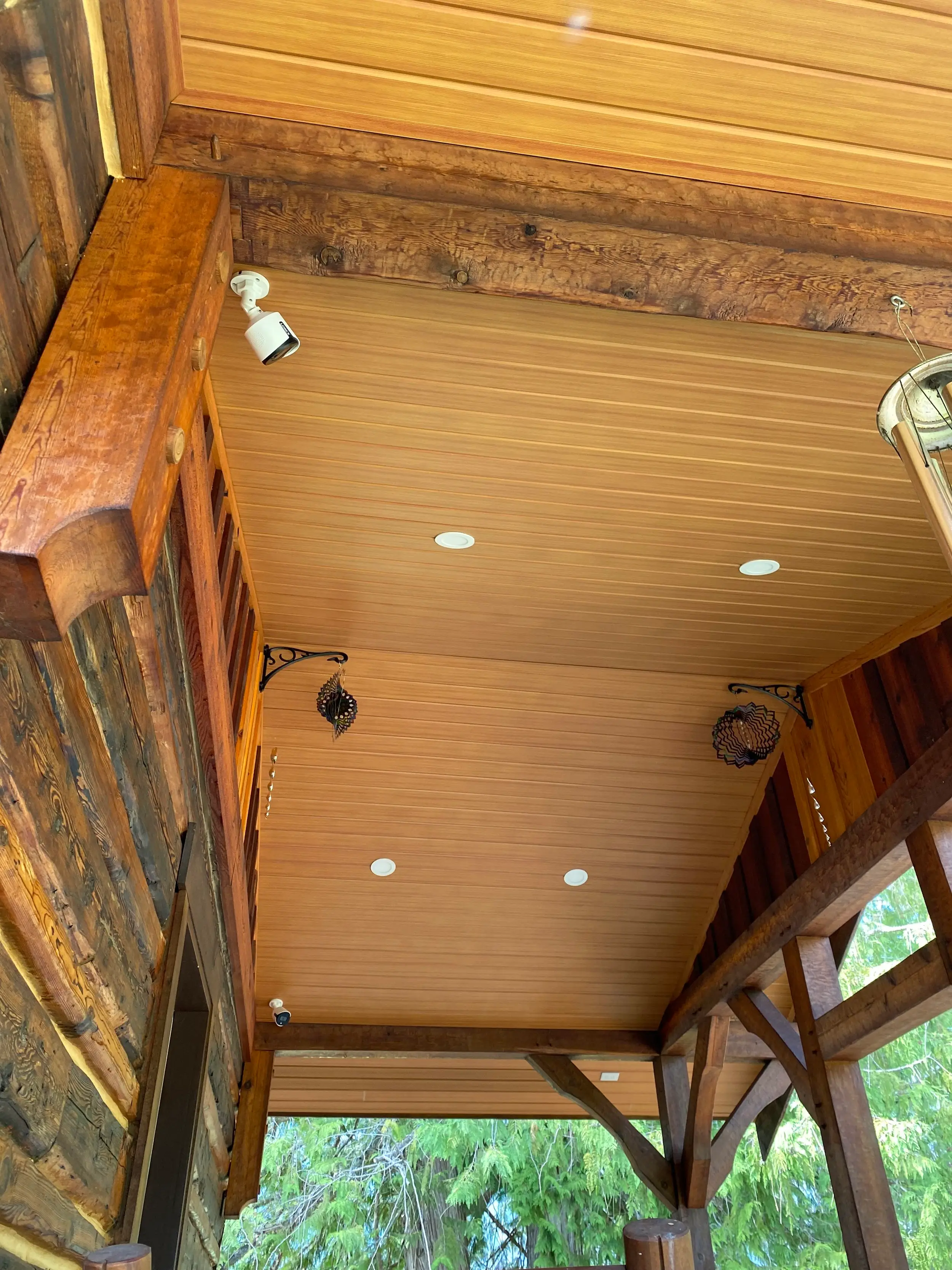 Porch ceiling finished in AFX woodgrain aluminum soffit with pot lights