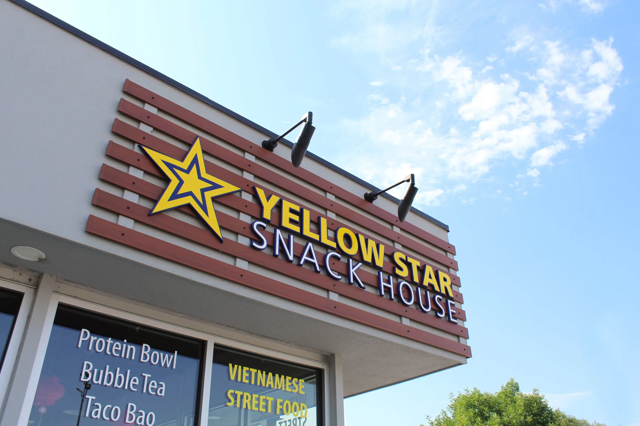 Restaurant storefront sign band clad in AFX woodgrain aluminum