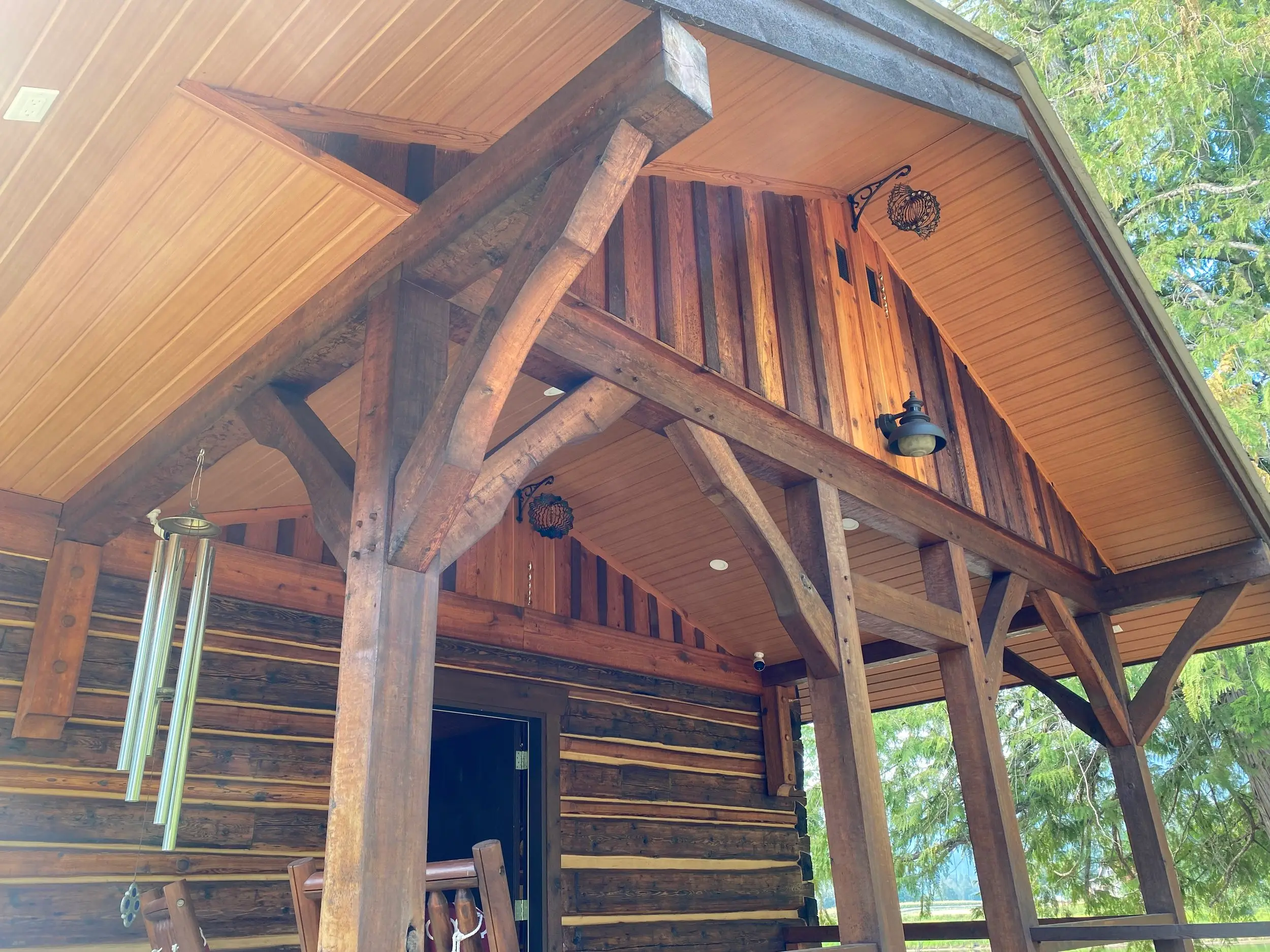 Covered timber-frame entry with an AFX woodgrain aluminum soffit ceiling